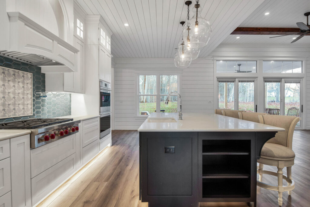 a large kitchen with a center island in the middle of the room