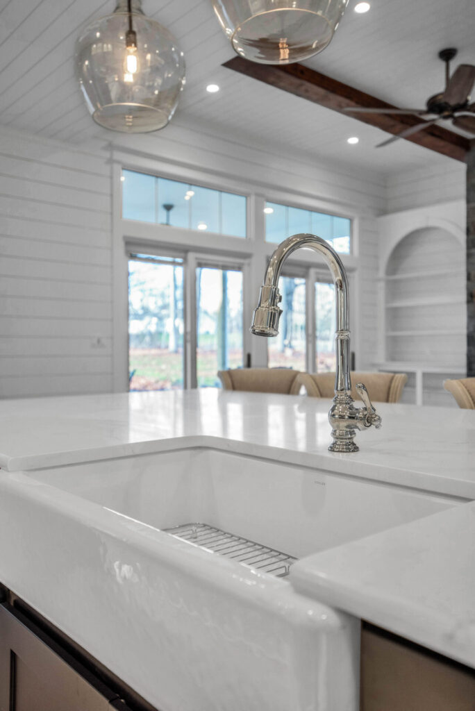 a kitchen with a sink and a ceiling fan