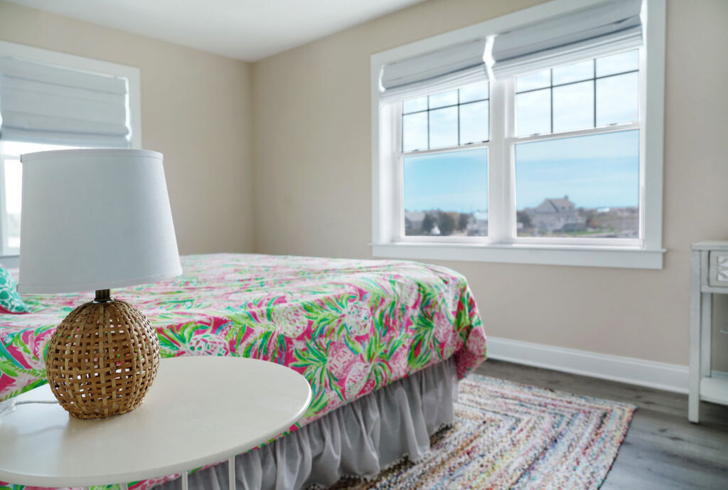 Bedroom with new windows with outside view and colorful bed and lamp