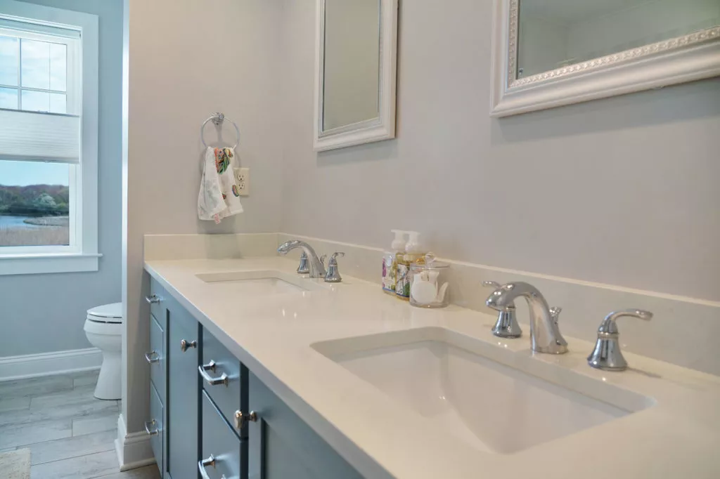 Bathroom with double sinks and new solid white countertops