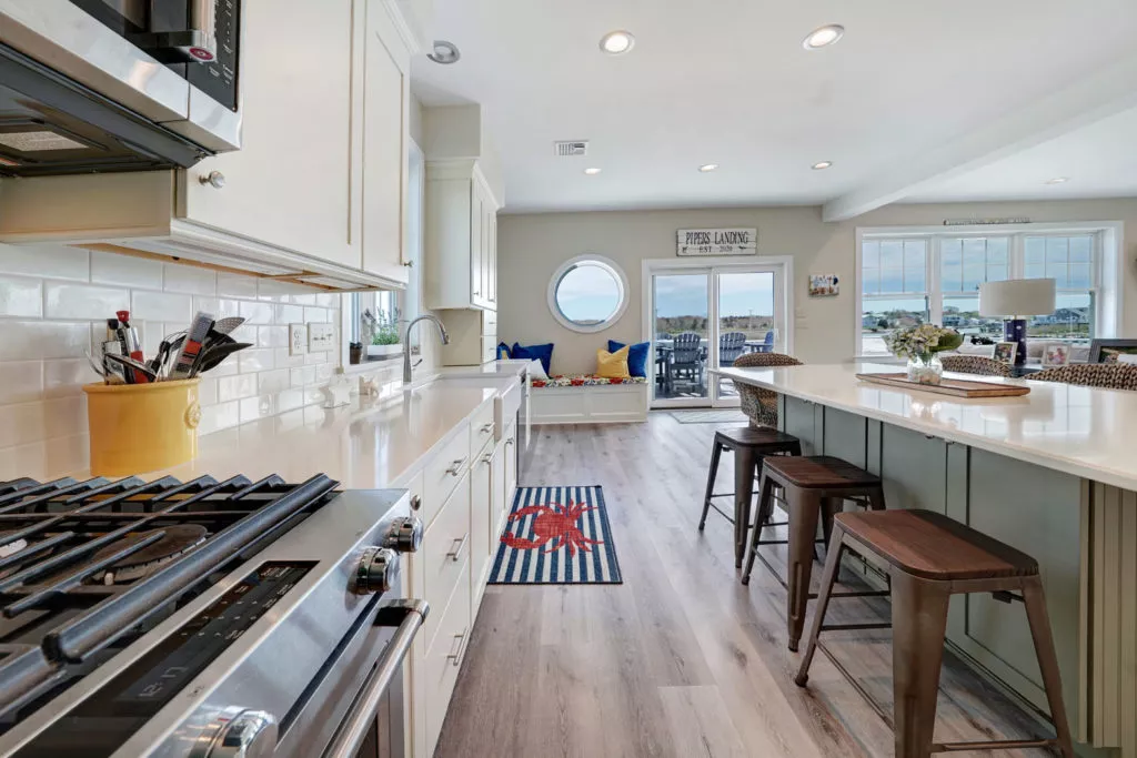 Kitchen with new cabinets, wood floor with island and bar seating