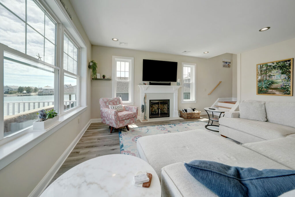 living room with a couch, arm chairs, and a fireplace