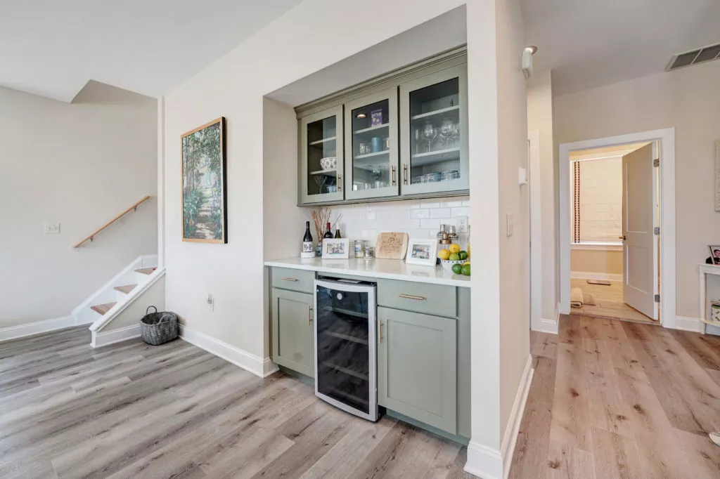 a built-in bar area with a wine fridge and storage