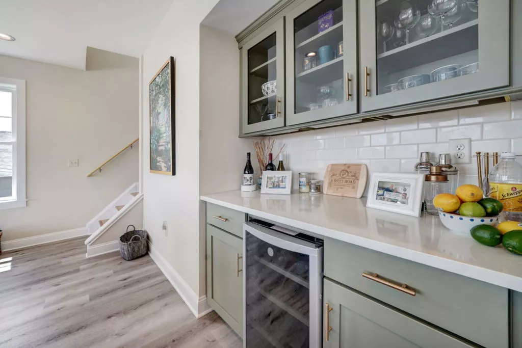 bar area with marble countertops and a wine fridge