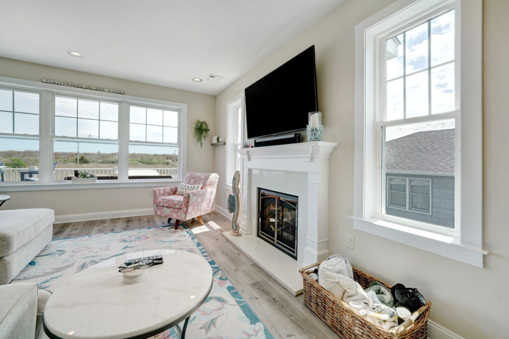 living room with light wood flooring and a fireplace with mantle