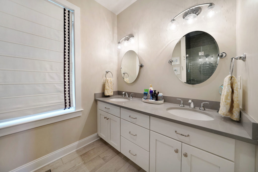 a bathroom with two sinks and white vanity