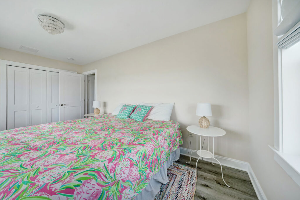 A bedroom with a large bed and a window built by Fidero & Sons in Meriden, CT.