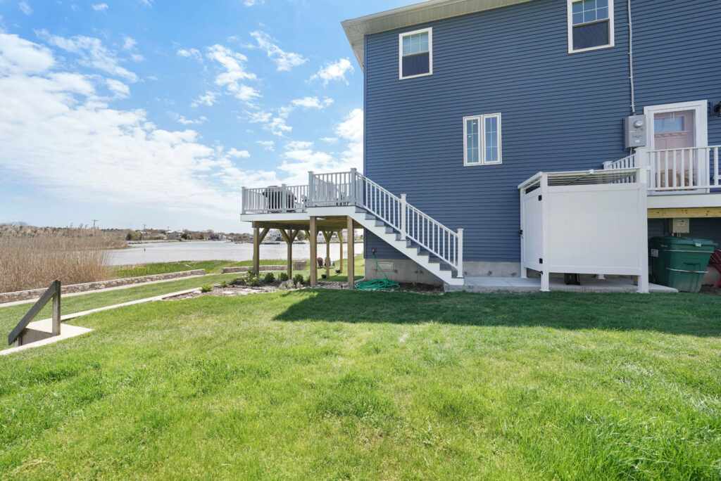 A large blue house with a deck on the side of it built by Fidero & Sons in Meriden, CT.