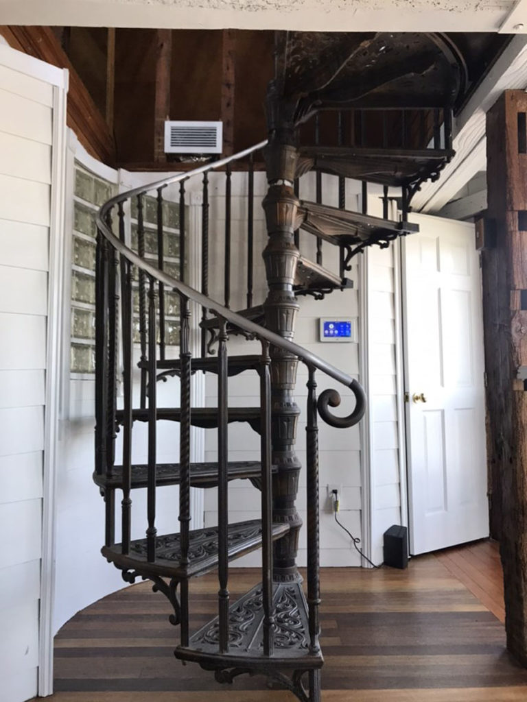 An ornate wrought-iron spiral staircase.