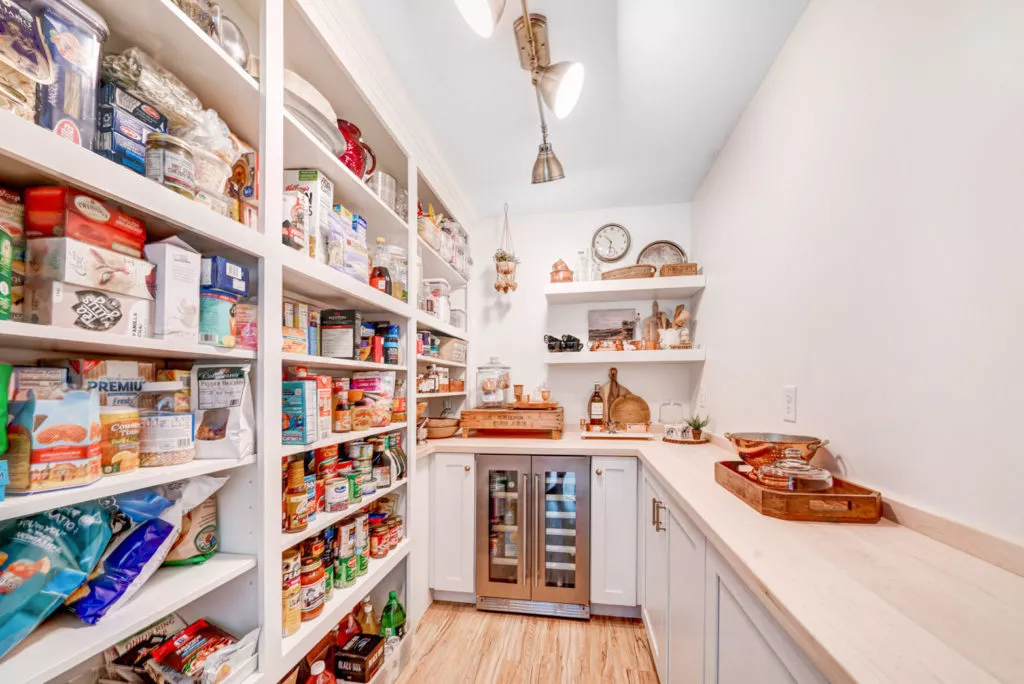 Large, organized, walk-in pantry inside home.