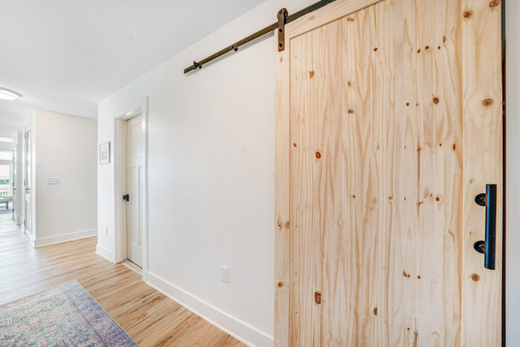 Wooden farmhouse style sliding door inside home.