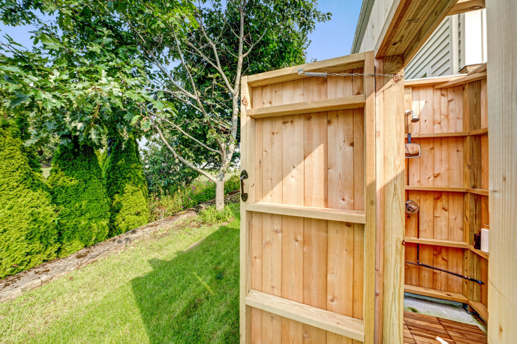 An outdoor shower with wood door.