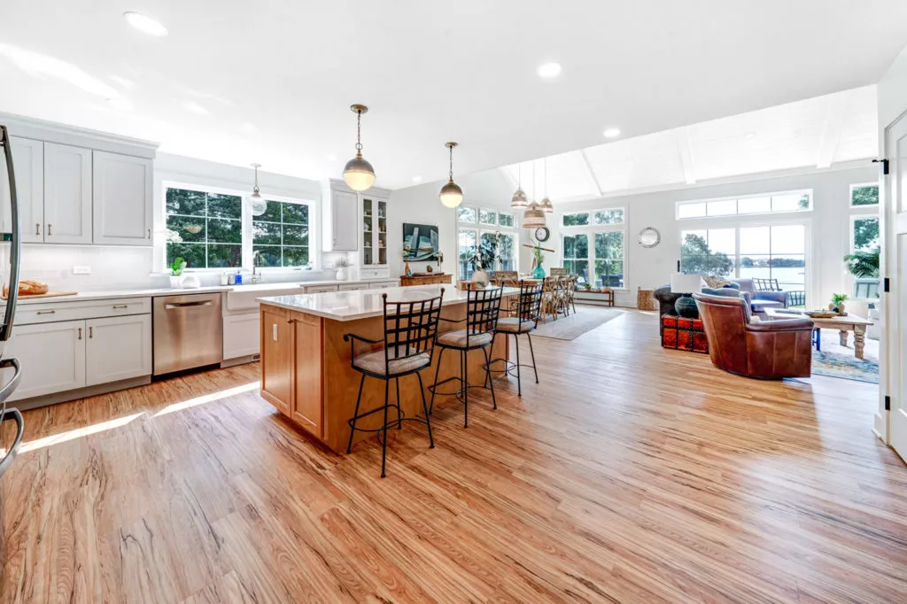 Open concept residential kitchen with chairs at an island.