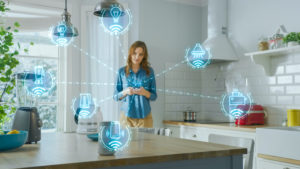 Young Woman Using Smartphone in Kitchen. She controls her Kitchen Appliances with IOT. Graphics Showing Digitalization Visualization of Connected Home Electronics Devices