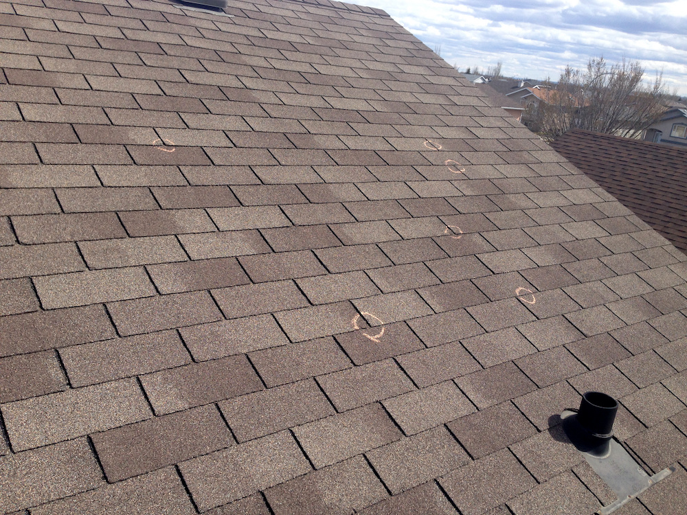 Close up of a brown roof with hail damage