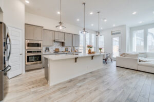 a large kitchen with a center island and stainless steel appliances