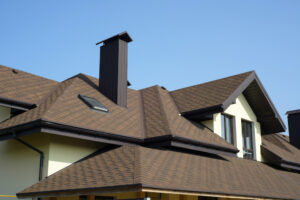 a house with a brown roof and two chimneys