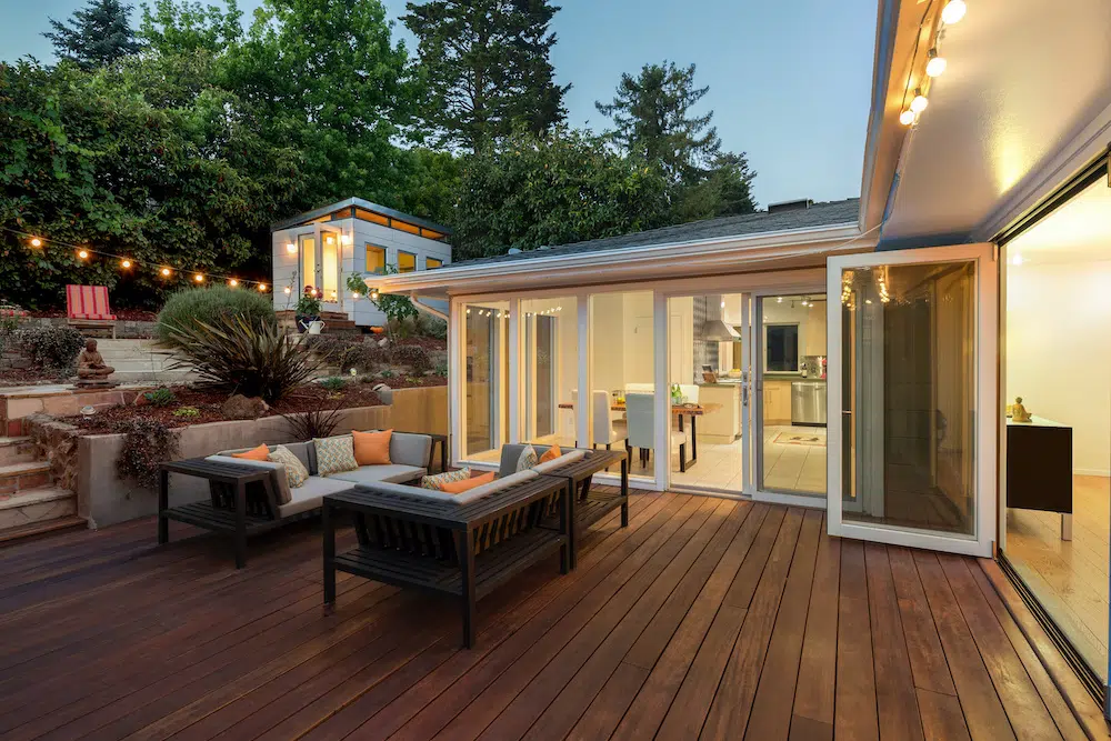 a deck with a couch and chairs on it