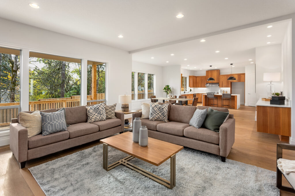 a living room filled with furniture and lots of windows